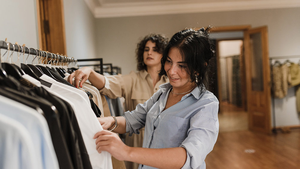 Women picking clothes from a store