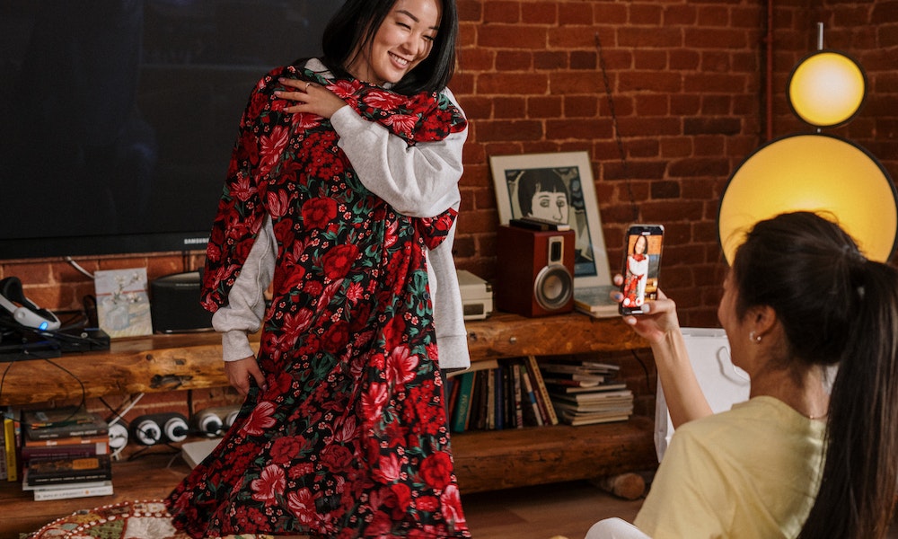 Woman smiling while trying out a dress