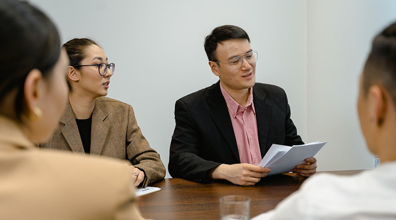 A man reading a report to give feedback to its team