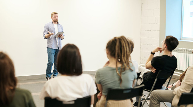 A man giving a lecture to some employees