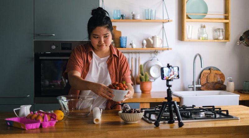 An influencer showcasing ingredients while cooking