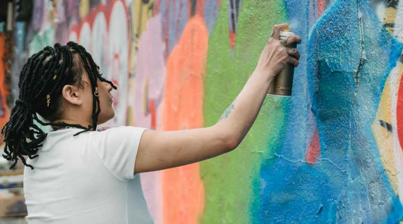 Woman doing a graffiti on a wall